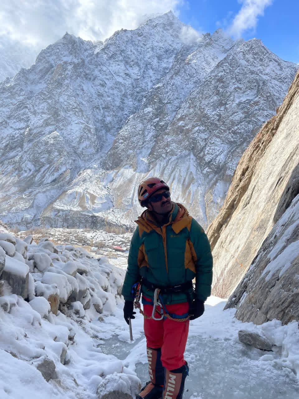 Ice climbing guide above Hushe village with winter peaks behind