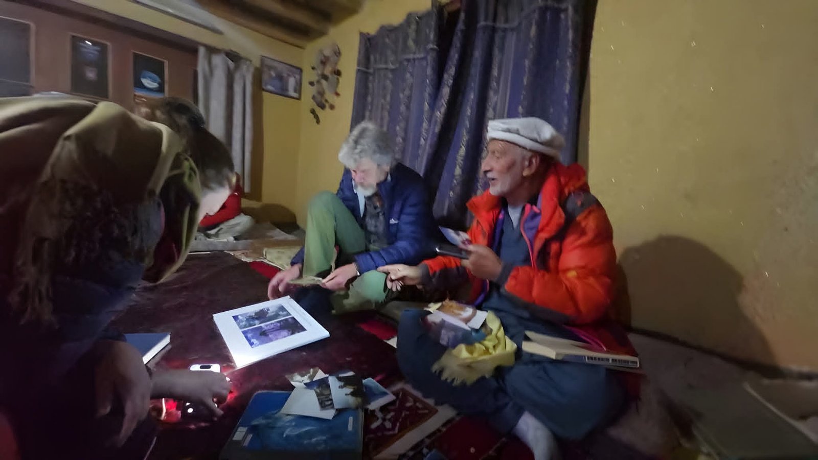 Reinhold Messner visiting Rozi Ali at his home, looking through old expedition photos, 2025